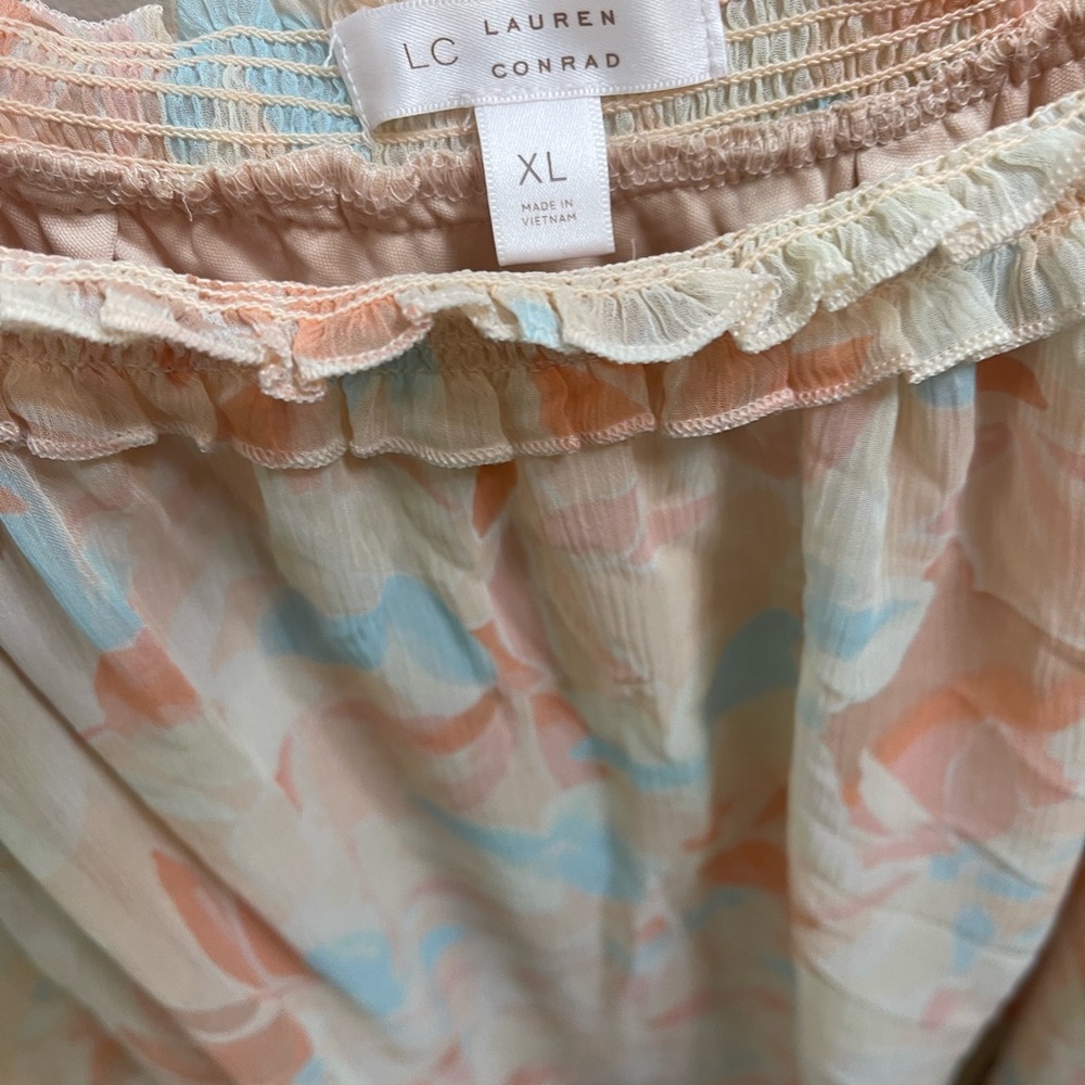 Feminine lightweight peach and cream color blouse.